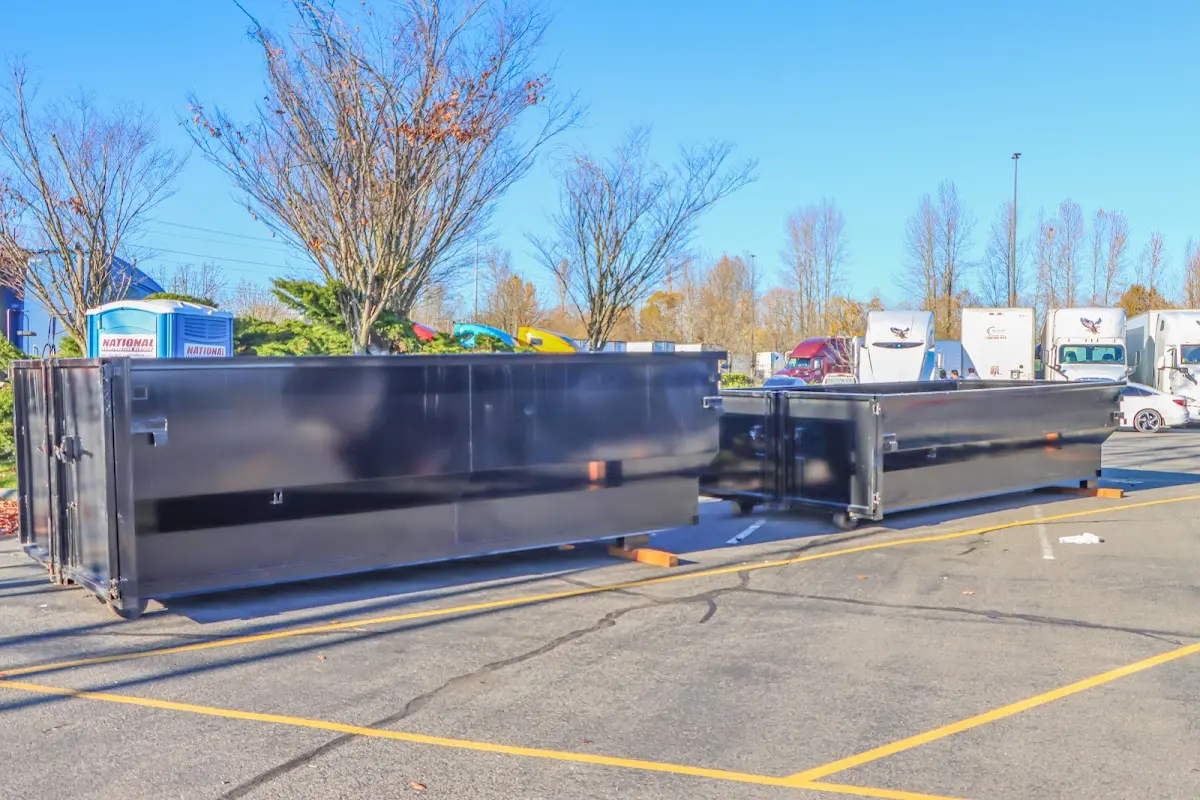 Professional dumpster rental service with roll-off container on residential driveway in South Cleveland